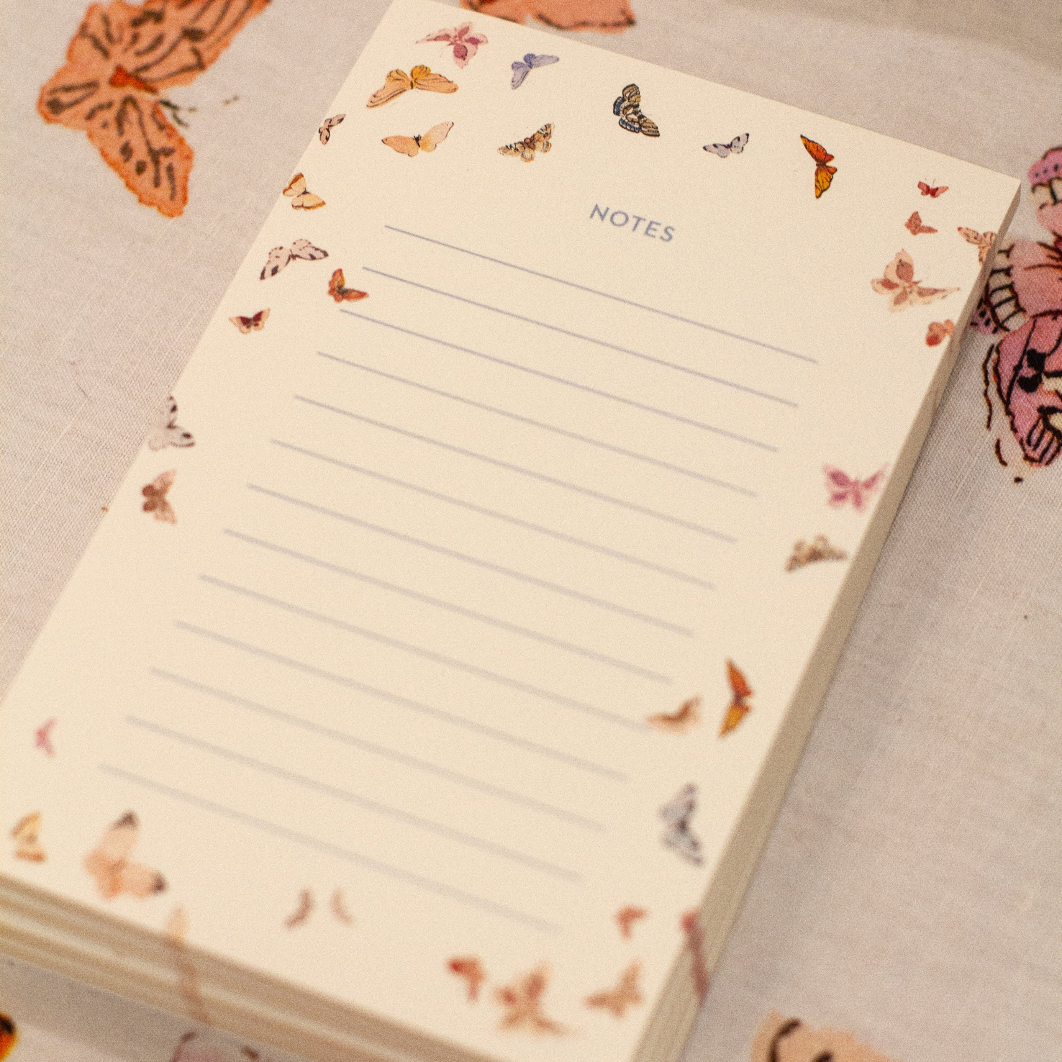 Notebook with butterfly designs on a light background inslee